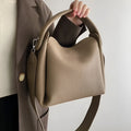 Grey women's corduroy shoulder messenger bag with adjustable strap, 24x10x17 cm, on a plain background.