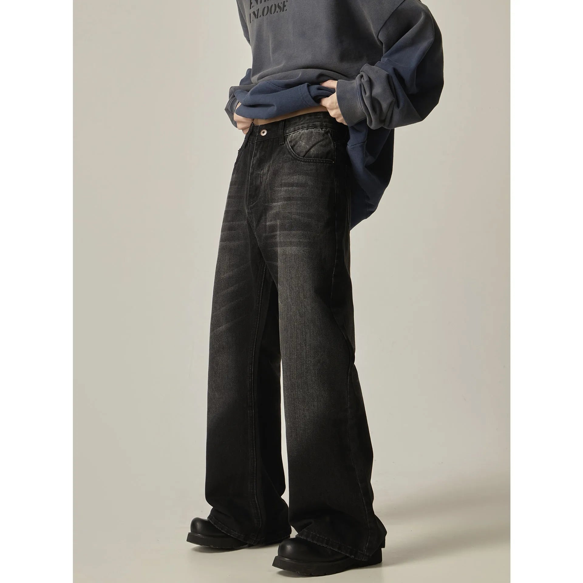 Black loose straight retro jeans with zipper fly on size chart background