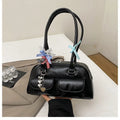 Women's black PU leather retro pillow handbag with double shoulder strap and flap closure.