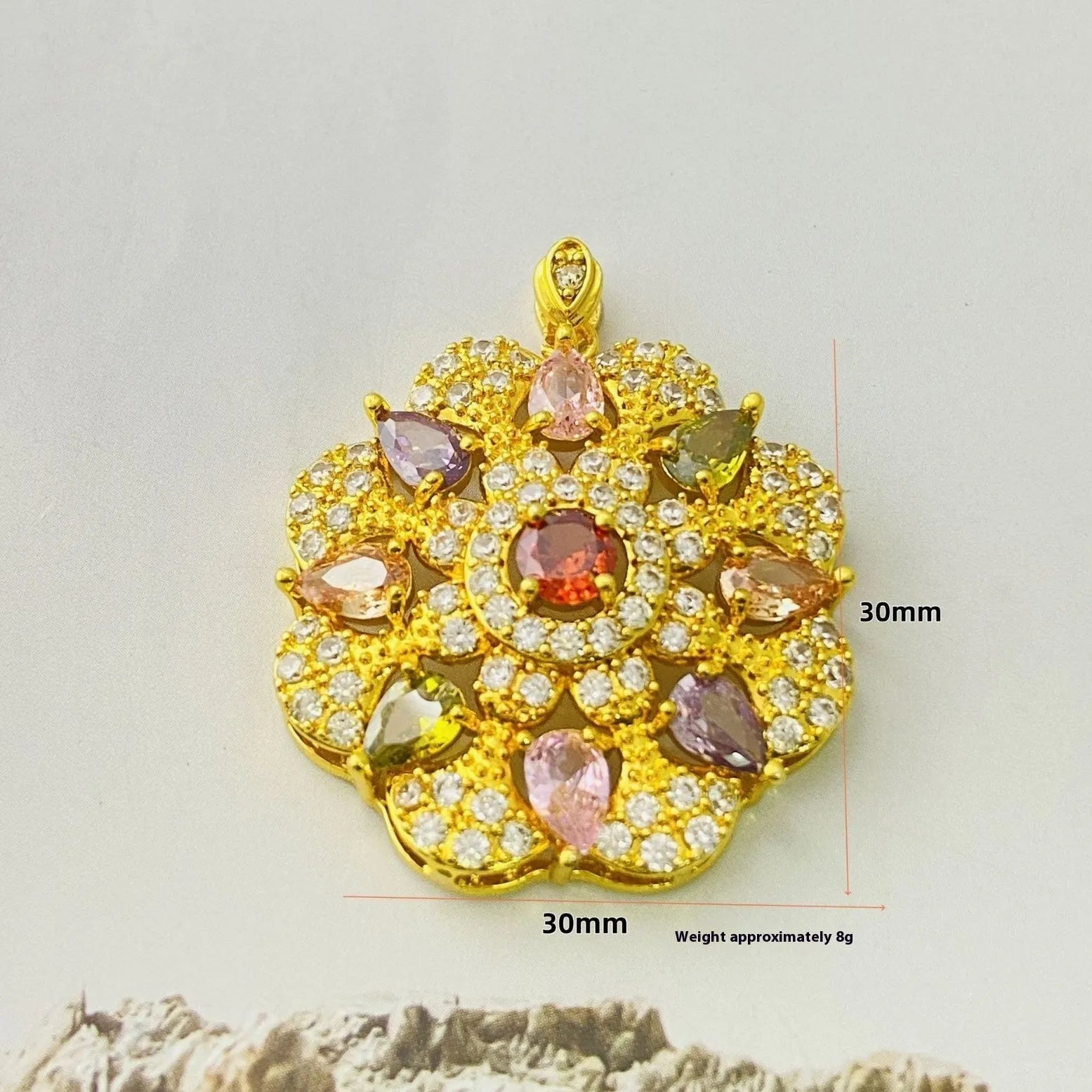 Close-up of a colourful zircon flower pendant necklace in a gold finish, showing floral detail.