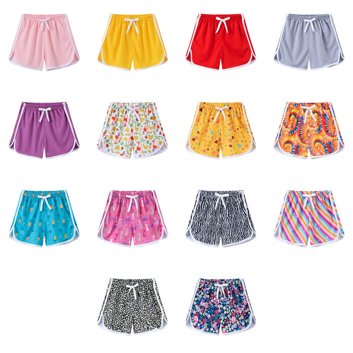 Children's polyester holiday shorts in multiple colours and patterns including stripes, leopard print, and pineapple design.