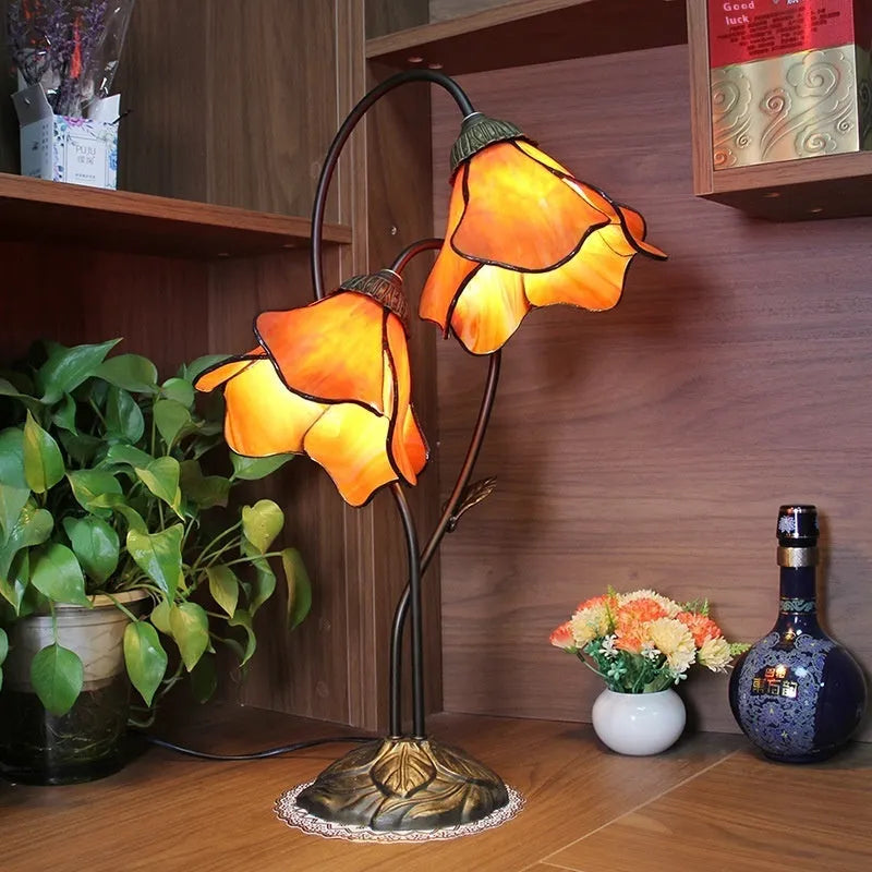 Retro American style desk lamp with lotus glass shade on wooden table.