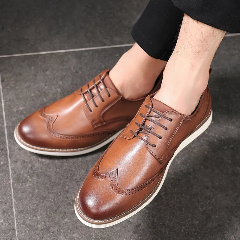 Men's black and brown slip-on business casual shoes with round toe and carved pattern detail