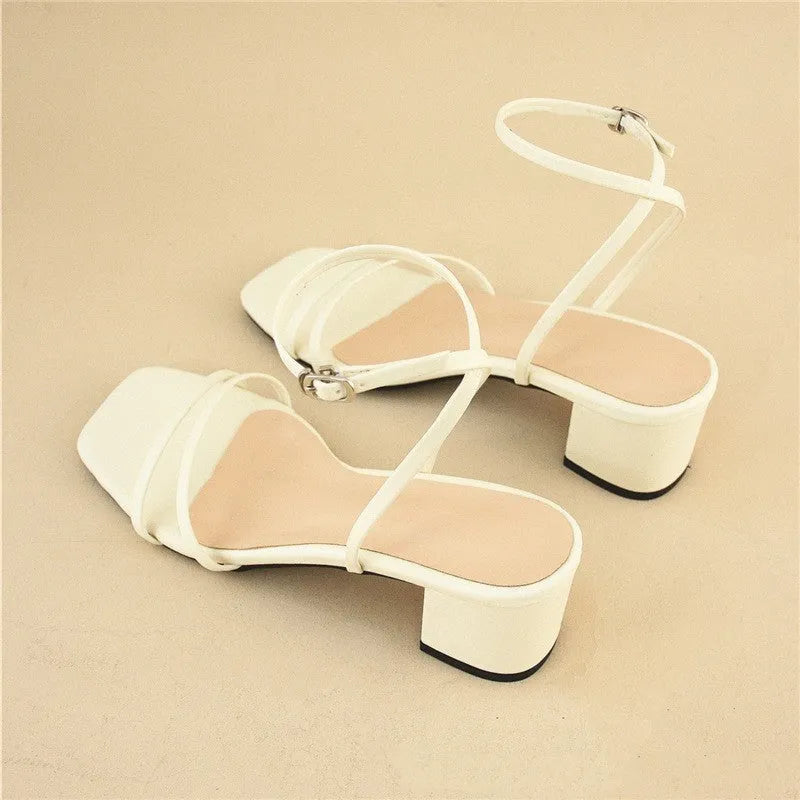 Beige women's sandals with a stiletto chunky heel, square toe, and an ankle buckle strap.