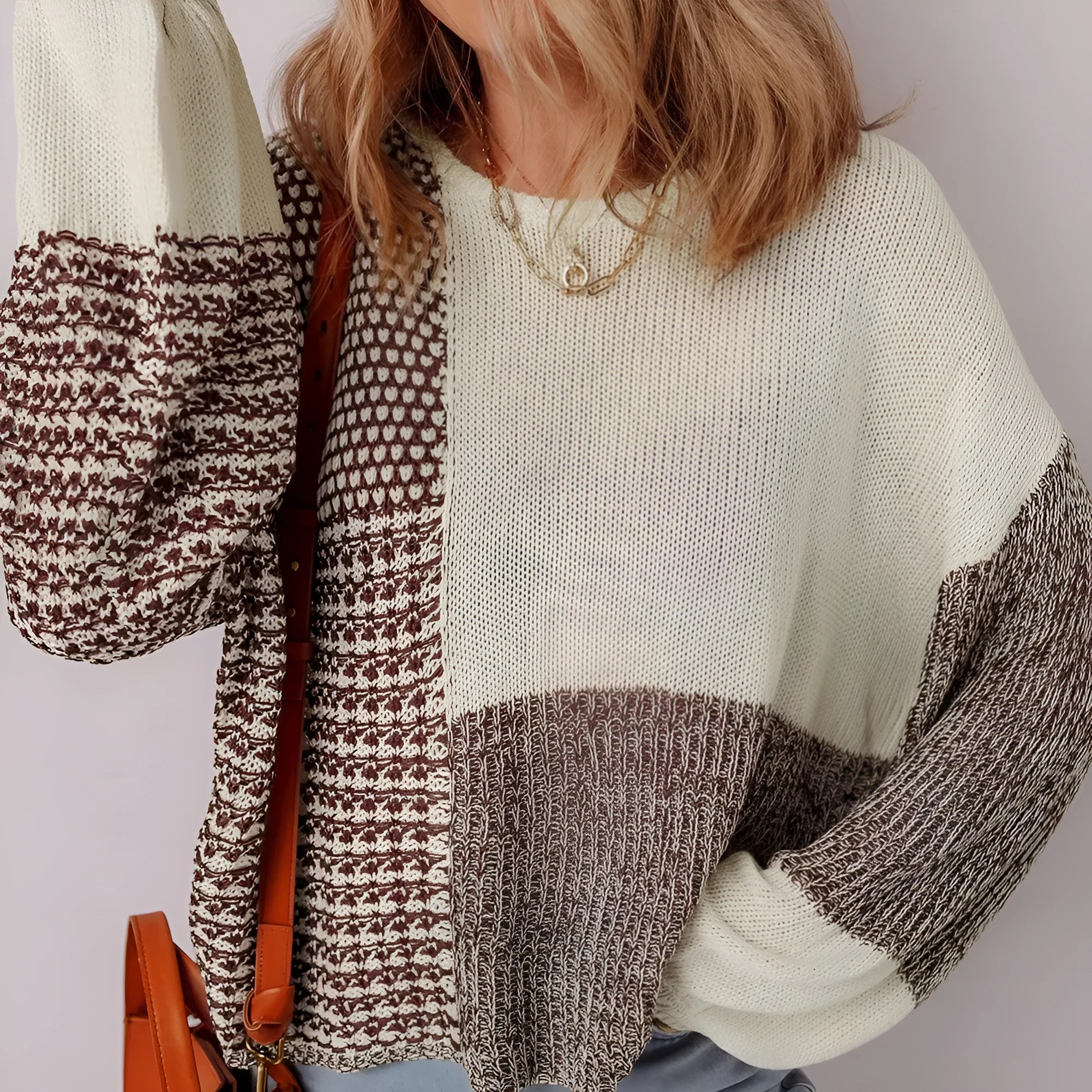 Dark khaki loose sweater with colour block design and back tie, on a model.