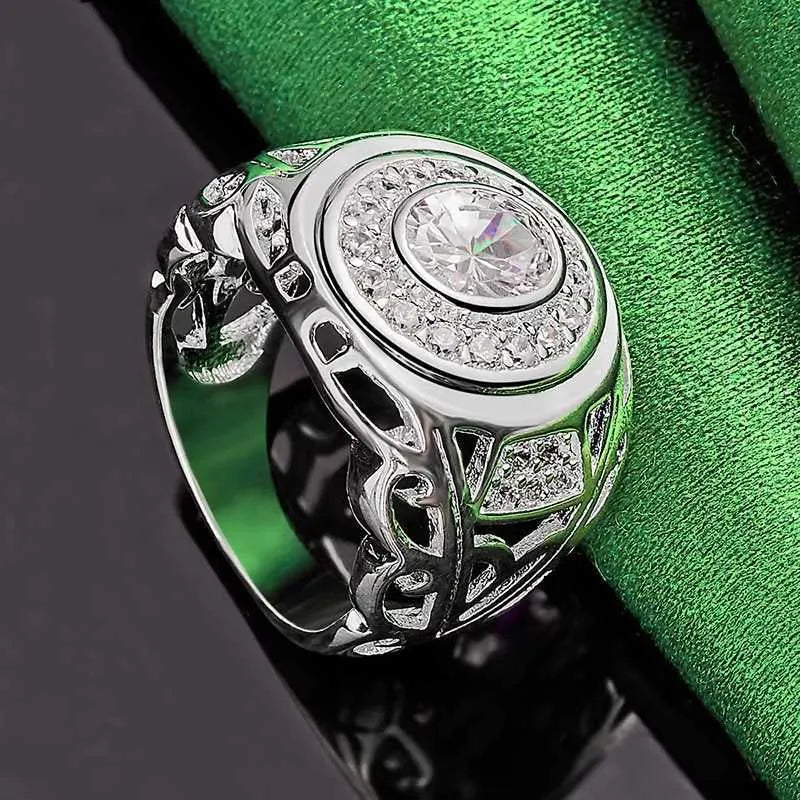 Silver round zircon ring on a flat surface, copper base with electroplated finish