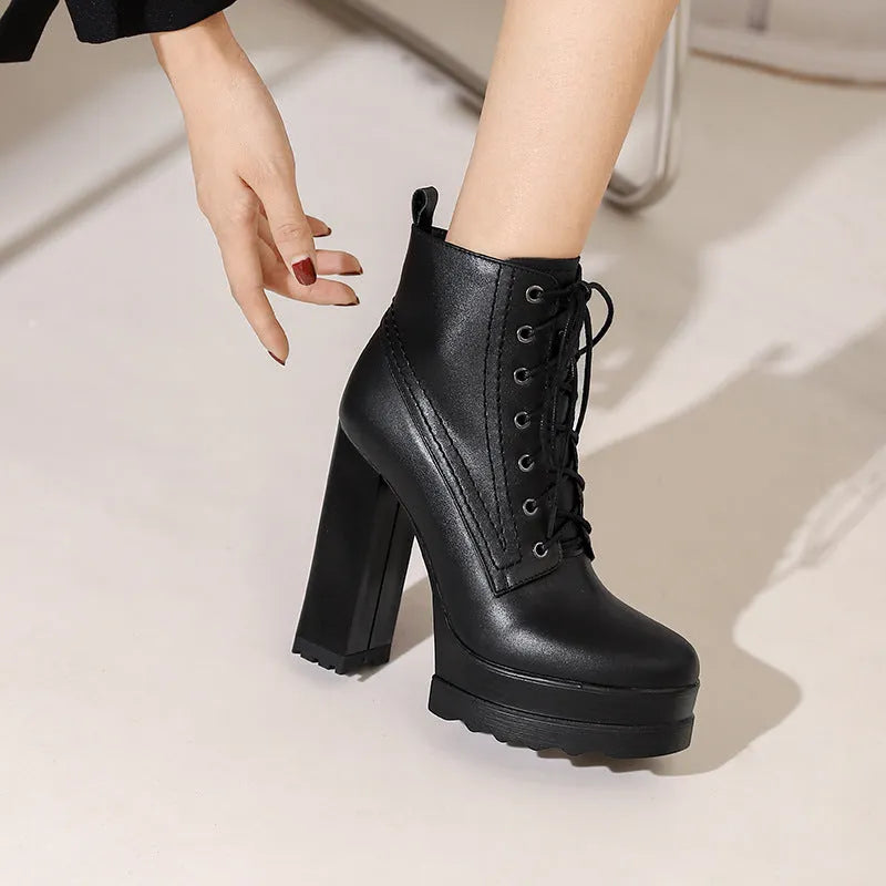 Black women's chunky heel waterproof platform boots with a side zip and round toe.