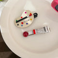Two plastic duckbill hair clips in green red and brown for women