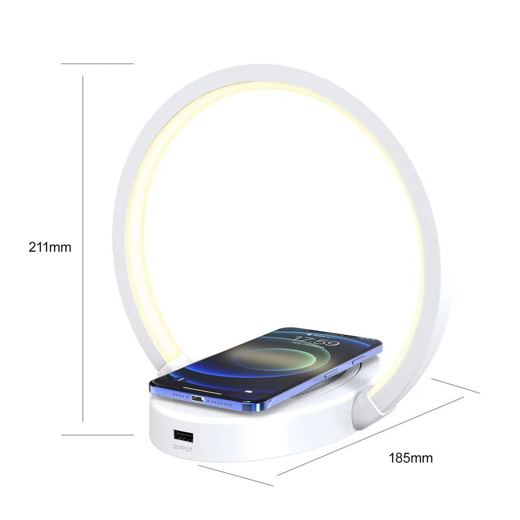 Wood grain wireless charging lamp with Bluetooth speaker, 10W charger, USB port, and phone holder on a desk