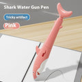 Shark water gun pen in blue plastic with press mechanism for water spray, on white background