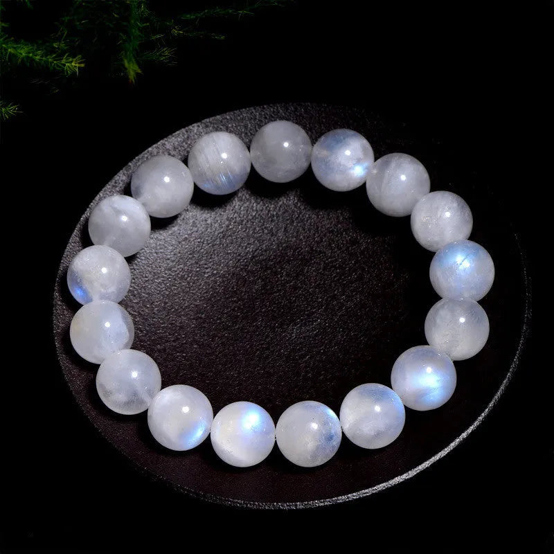 Natural blue moonlight round moonstone bead bracelet on a white background showing polished gemstone beads.