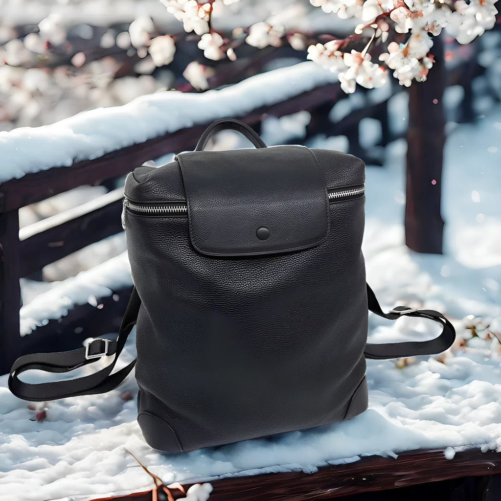 Black full-grain leather backpack, 30 x 13 x 35 cm, with curved shoulder straps and patchwork front