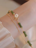Natural olivine double layer bracelet with braided cord and Bells of Ireland design