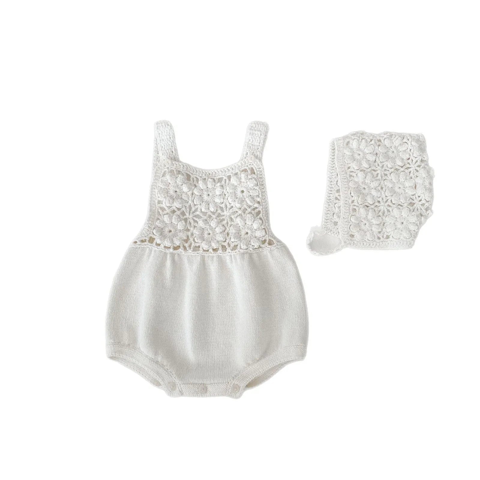 Beige baby romper with flower cutout strap and matching hat on a baby girl
