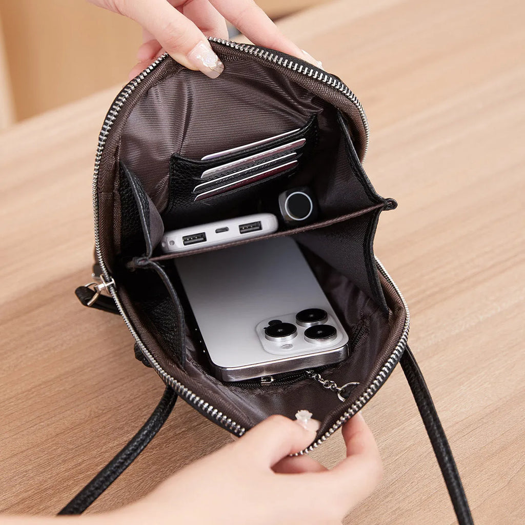 Simple women's vertical crossbody bag in solid colour with stitching details and single strap