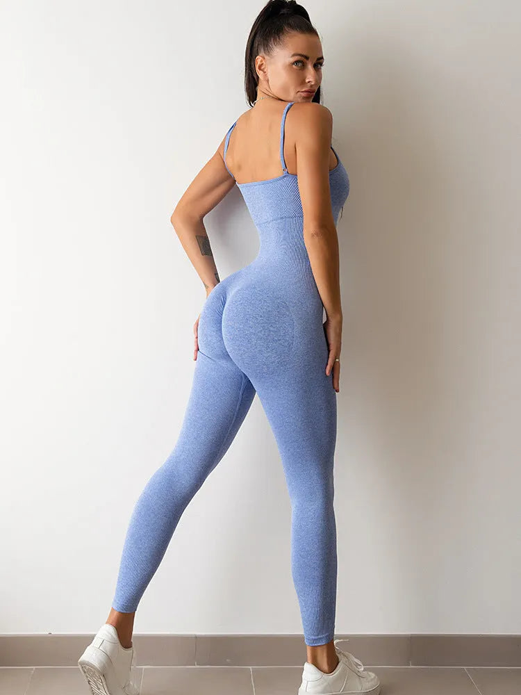 A woman wearing a black sleeveless unitard jumpsuit with spaghetti straps, showing the backless design and close fit.