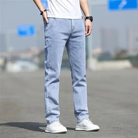 Men's straight-leg jeans in smoky grey colour with low waist design and zipper fly closure