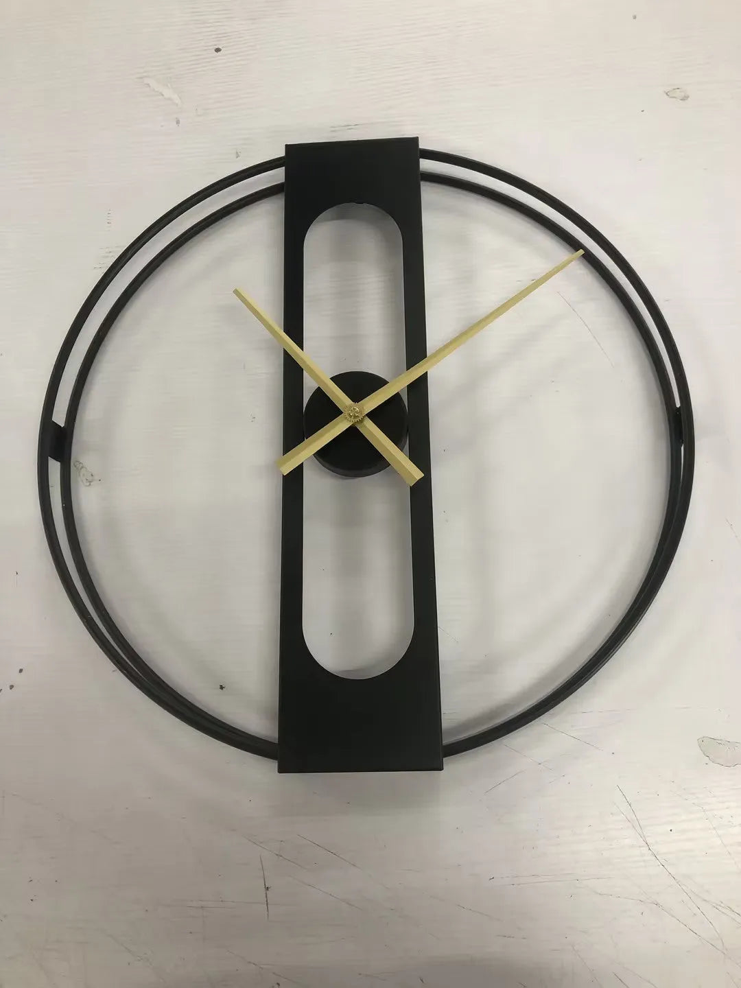 50 cm round metal wall clock on a wall in black and gold colour options
