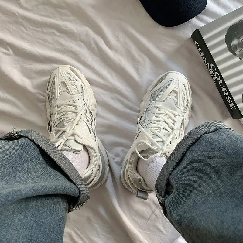 A pair of casual solid-colour sports shoes with a round toe and lace-up closure, shown in one of the available colours.