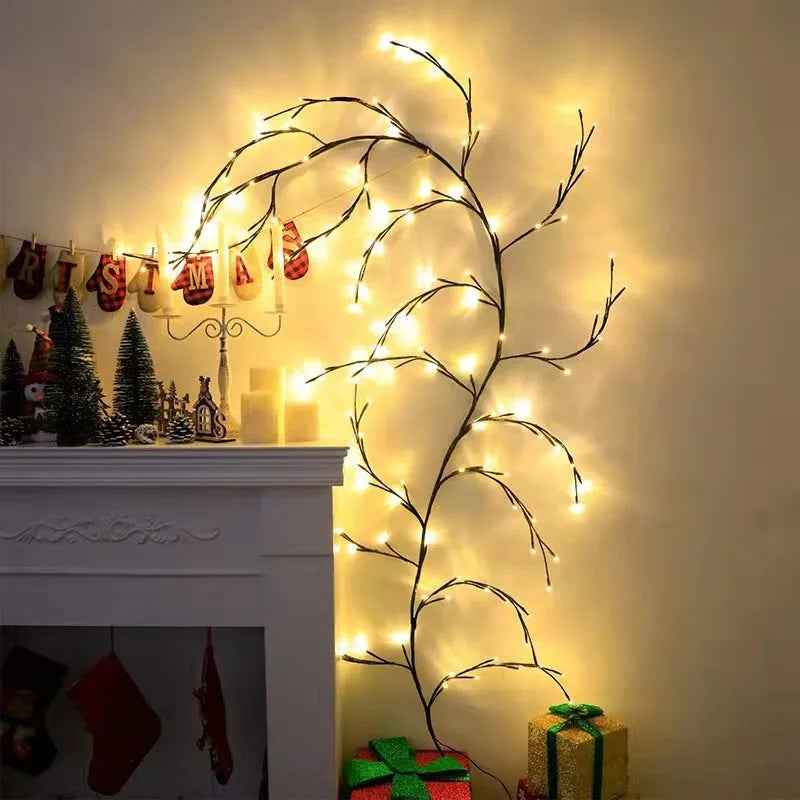 Flexible willow vine Christmas garland with warm white LED lights bent into a decorative shape on a wall.