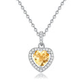 Sterling silver heart pendant necklace with inlaid gemstone on a cross chain for women.