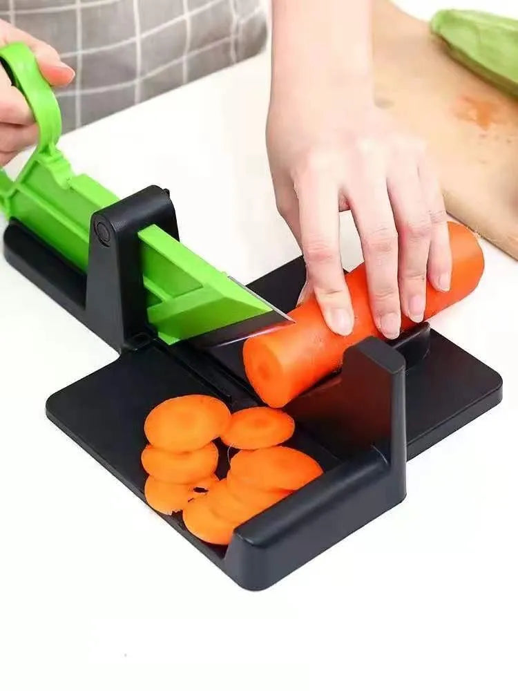 Green kitchen vegetable cutter with stainless steel blades for cutting carrots and potatoes
