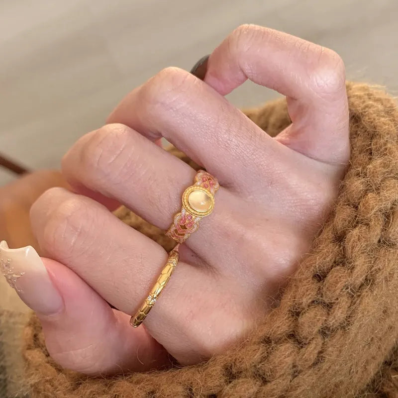 Pink crystal enamel geometric open-mouth ring on a gold-plated copper band.