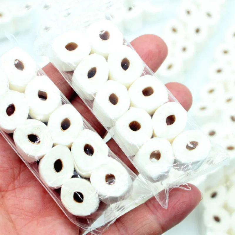 Miniature simulated toilet paper roll model made from paper for dollhouse and children's pretend play.