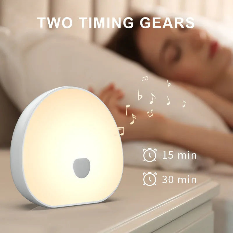 White rechargeable baby night feeding comforter with music function on a neutral background