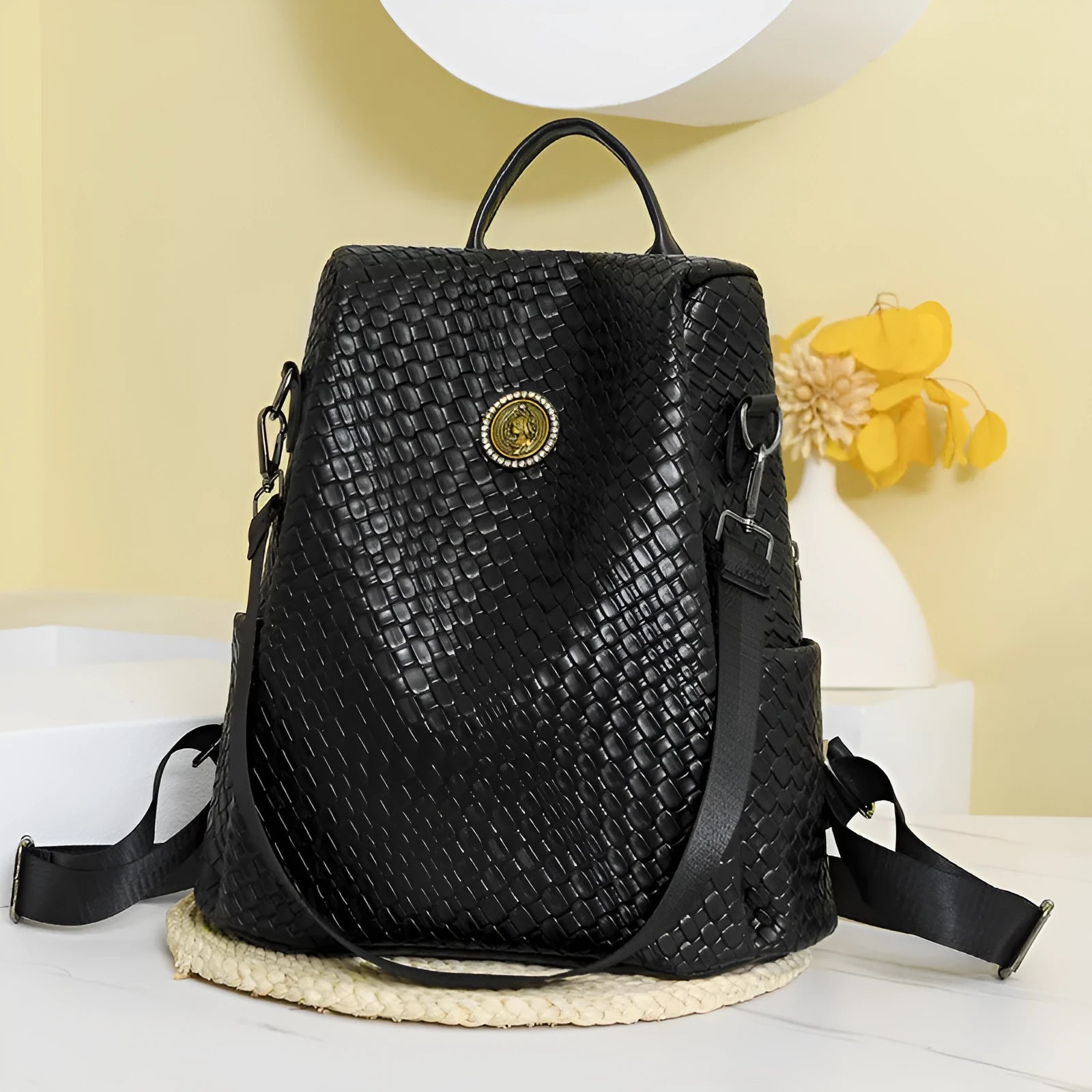 Black women's anti-theft backpack with weaving detail and multiple compartments for travel