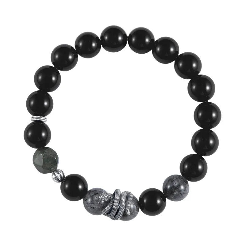 Men's black obsidian and sterling silver snake bracelet with retro design on a wrist.