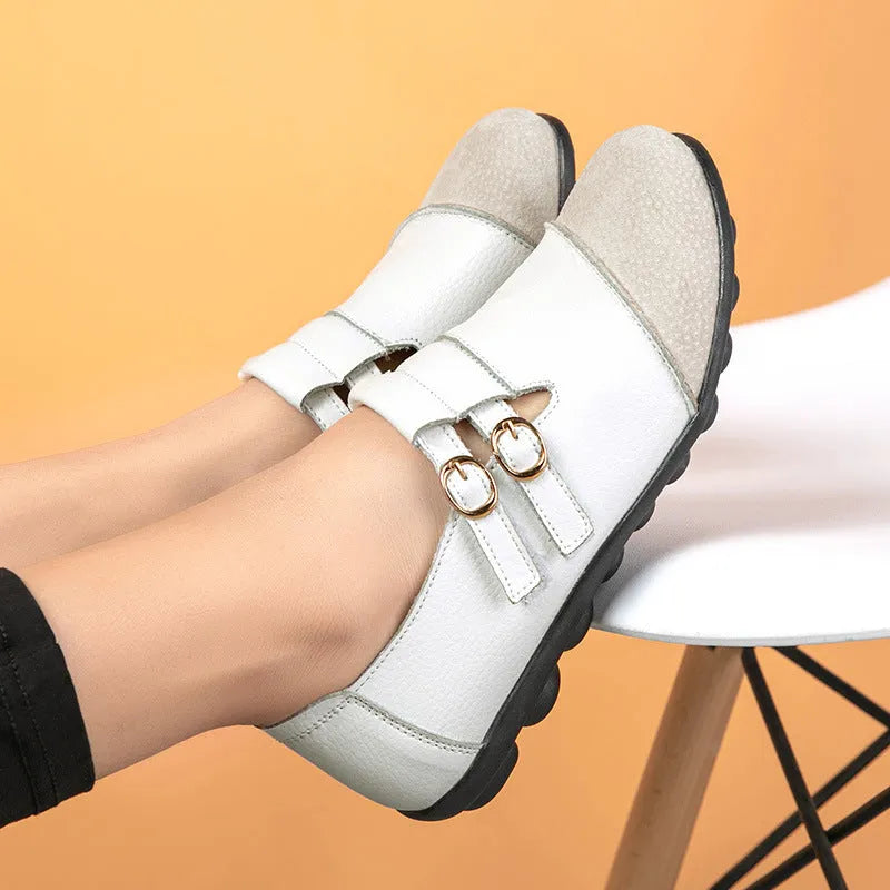 Casual low-top leather flat shoes with a round toe and a single Velcro strap closure.