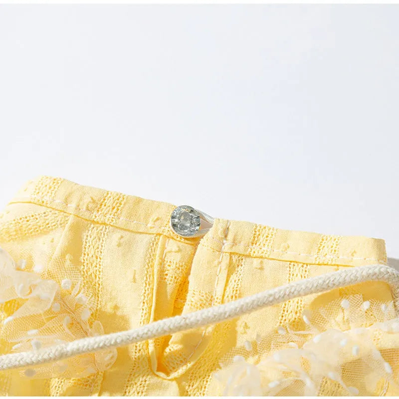 Small dog wearing yellow two-tone country shoulder bag outfit with matching bow and woven crossbody bag