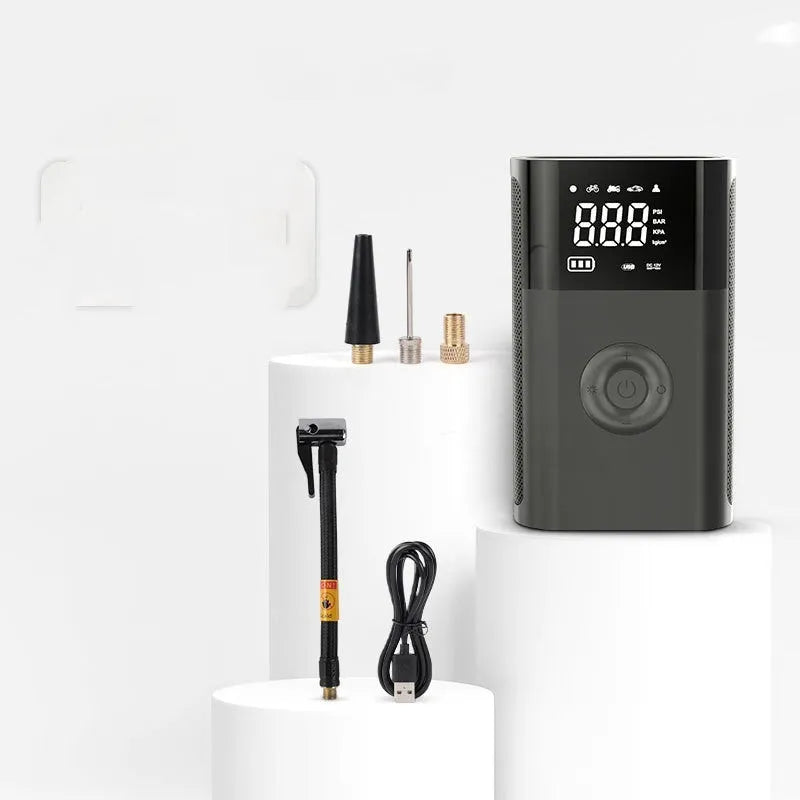Handheld wireless digital car tyre inflator with LCD screen, made from black ABS plastic, shown with charging cable and nozzle adaptors.