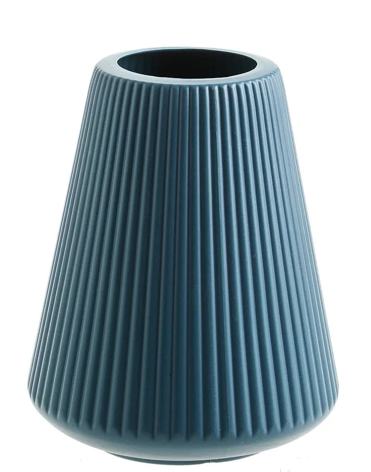 Blue, green, pink, and white melamine plastic decorative vase measuring 16cm by 20cm on a desktop.