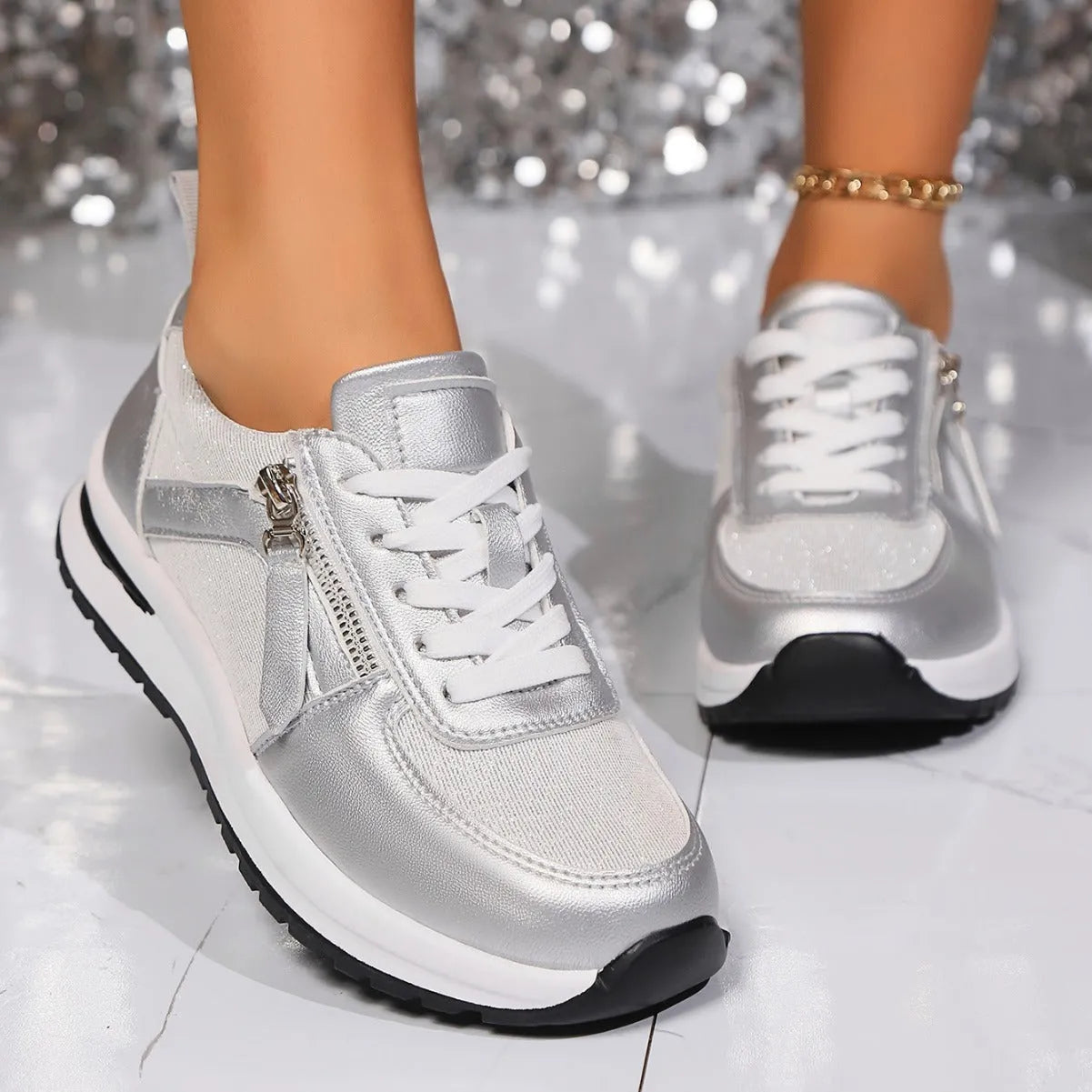Gold women's lace-up pumps with round toe and flat rubber sole on a white background