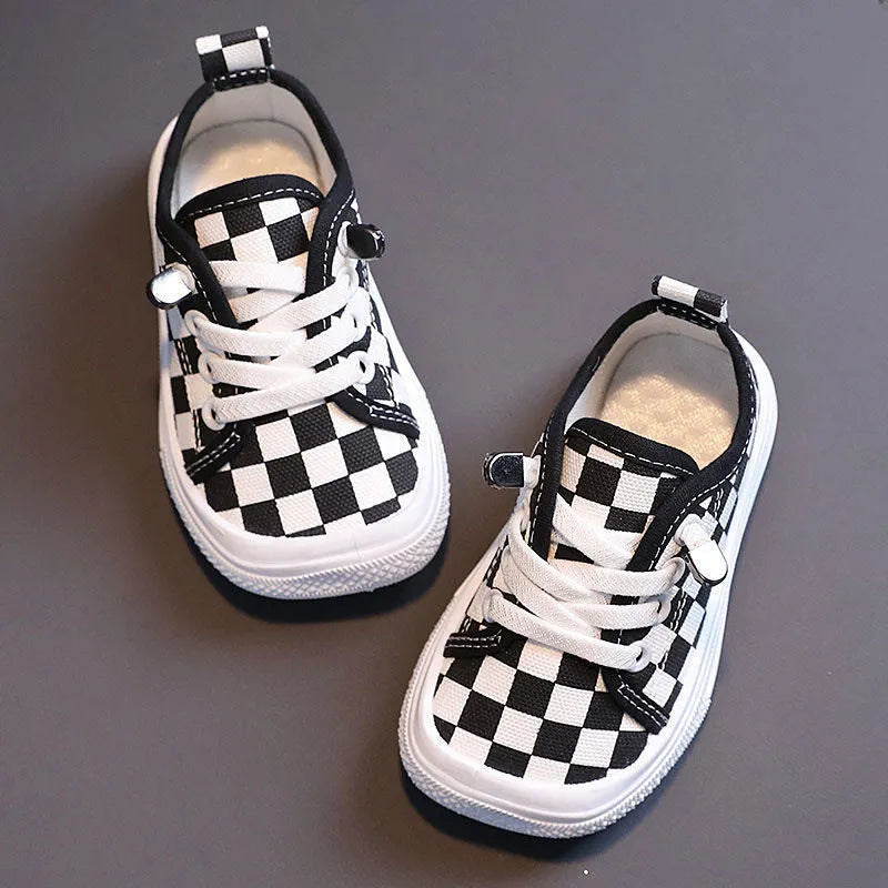 Children's canvas shoes low top sneakers in orange black white leopard print and plaid on a white background