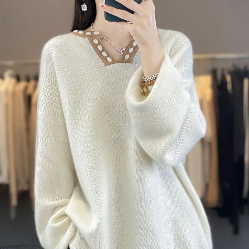 Women's camel coloured V-neck long sleeve viscose sweater on a hanger.
