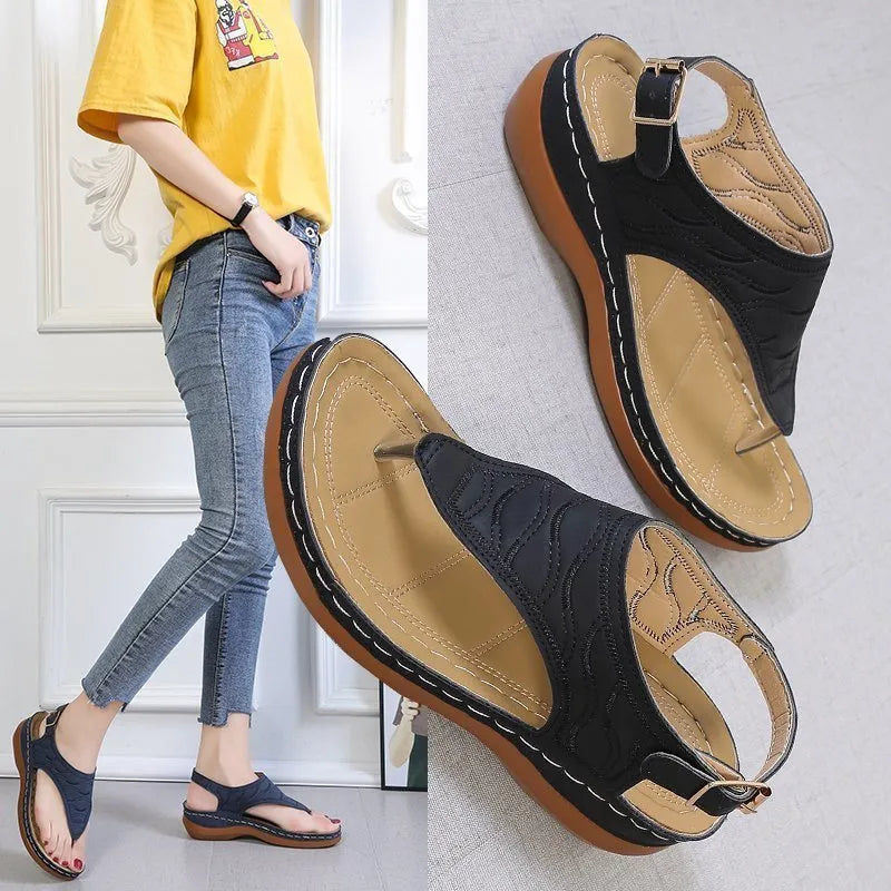 Women's wedge heel sandal in a solid colour with an adjustable back strap buckle.