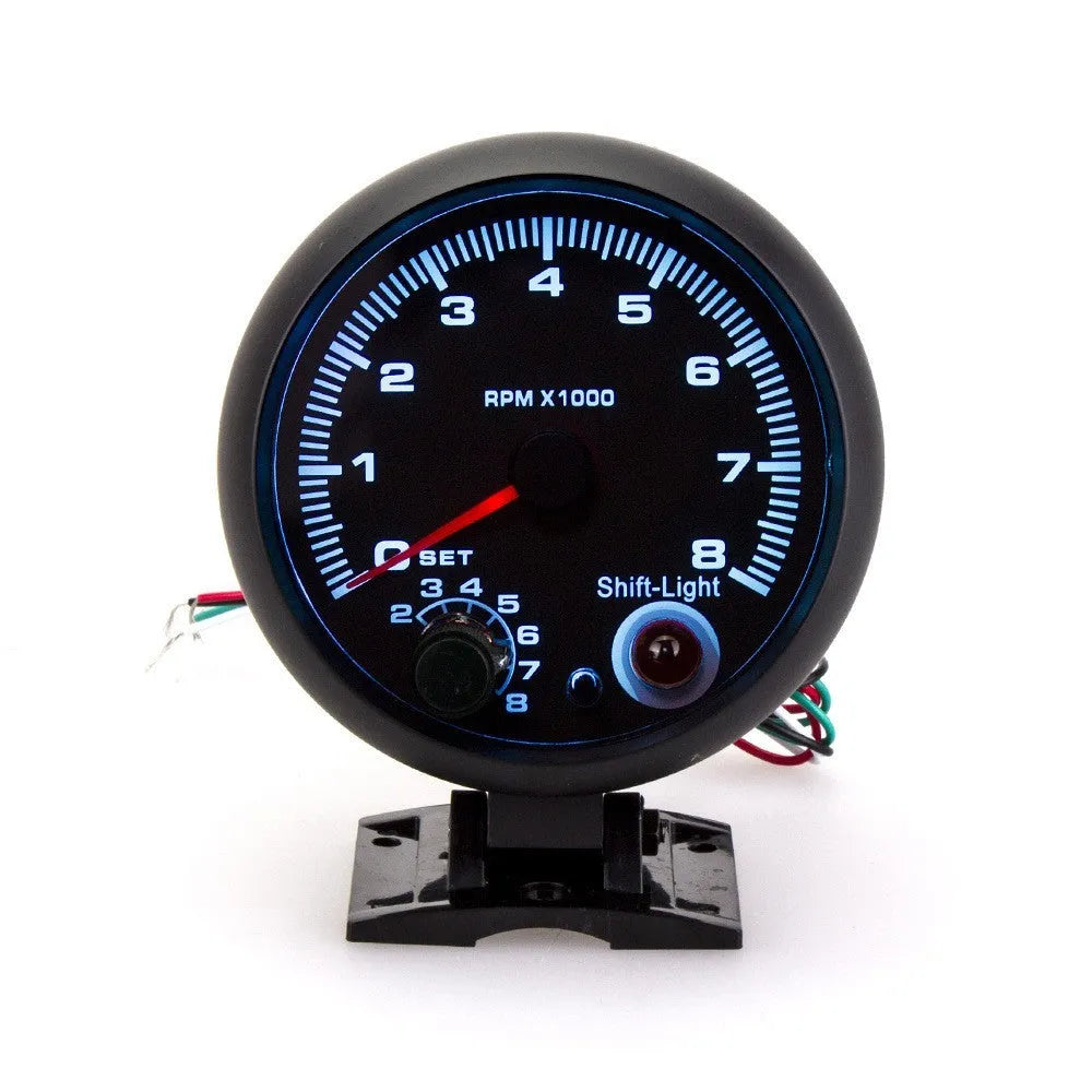 Black automotive tachometer with blue illuminated pointer display showing rpm measurement scale