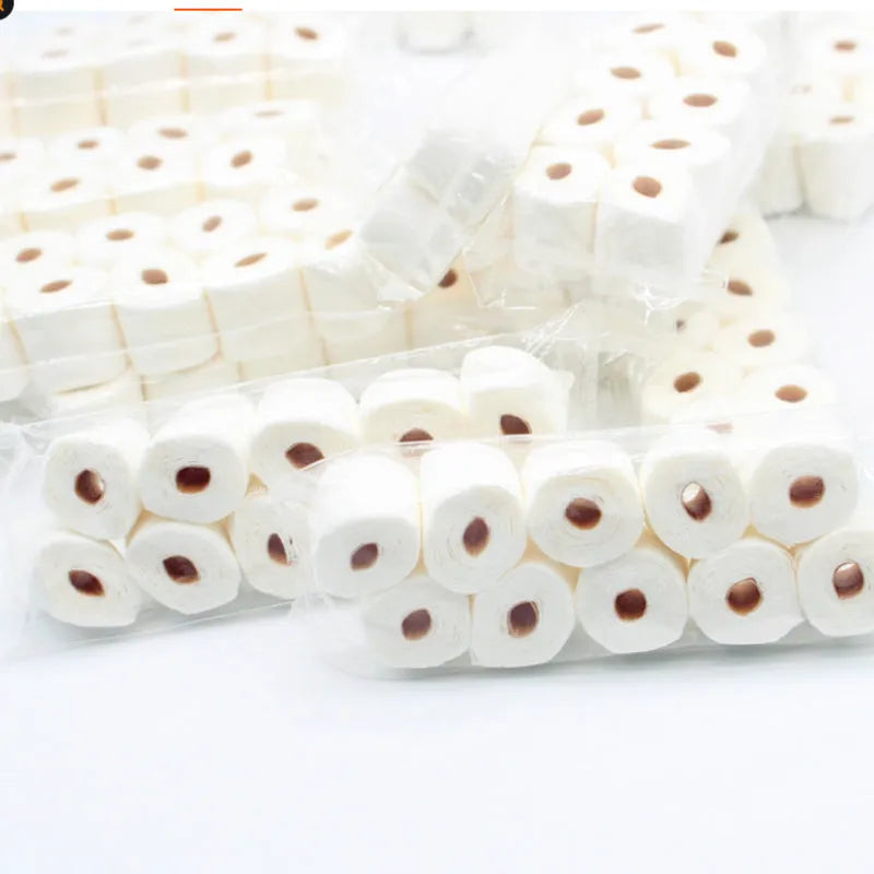 Miniature simulated toilet paper roll model made from paper for dollhouse and children's pretend play.