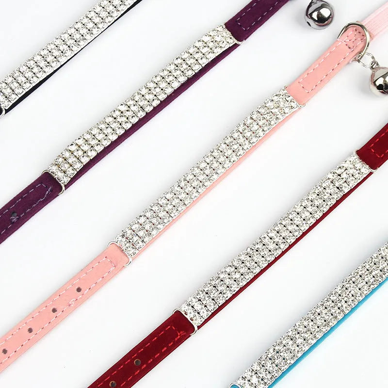 Red velvet cat collar with rhinestones, adjustable buckle, shown on a white background.