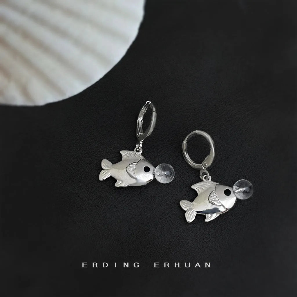 A pair of goldfish-inspired bubble fish design earrings with an electroplated finish on a copper base.