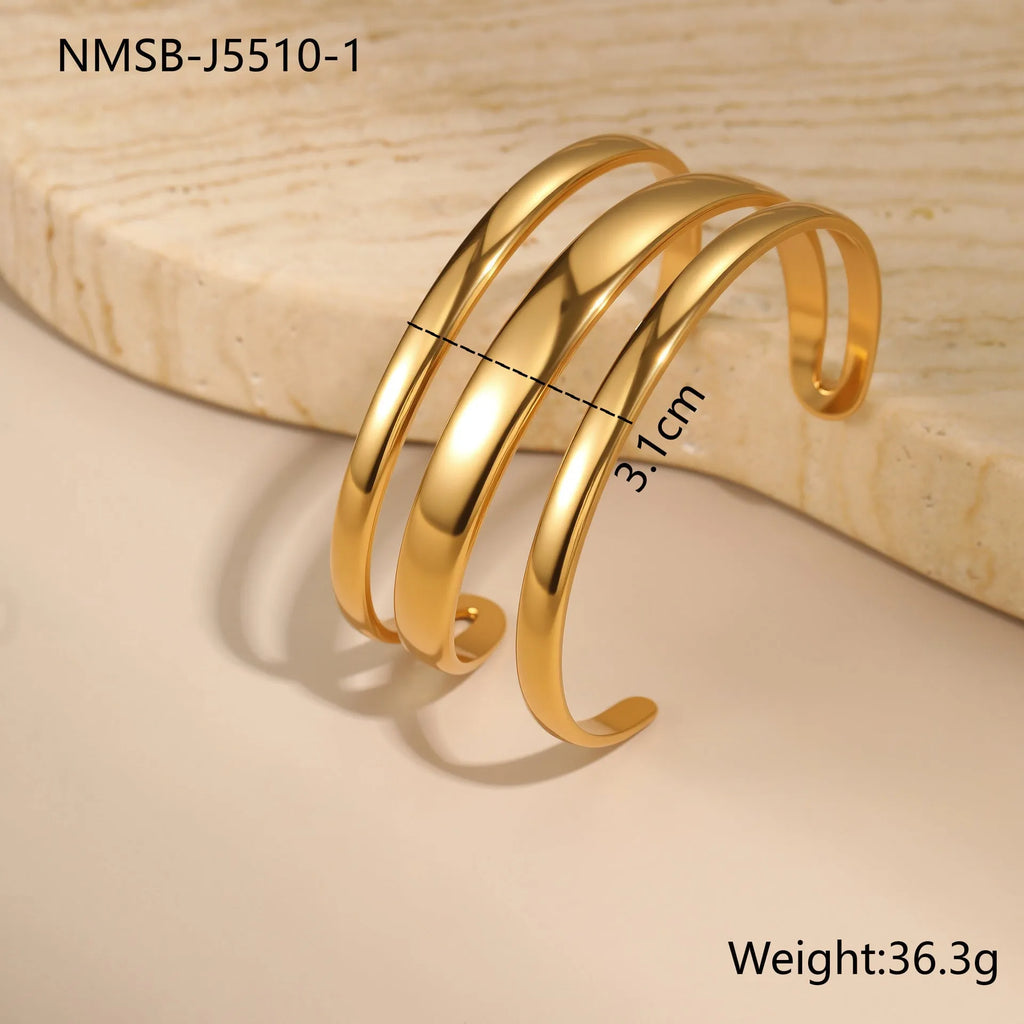 Women's stainless steel simple opening bracelet with geometric line design in gold or steel colour.