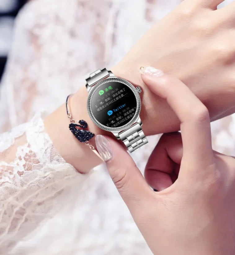 AK38 ladies smart watch with stainless steel Milanese mesh band and colour screen displaying time.