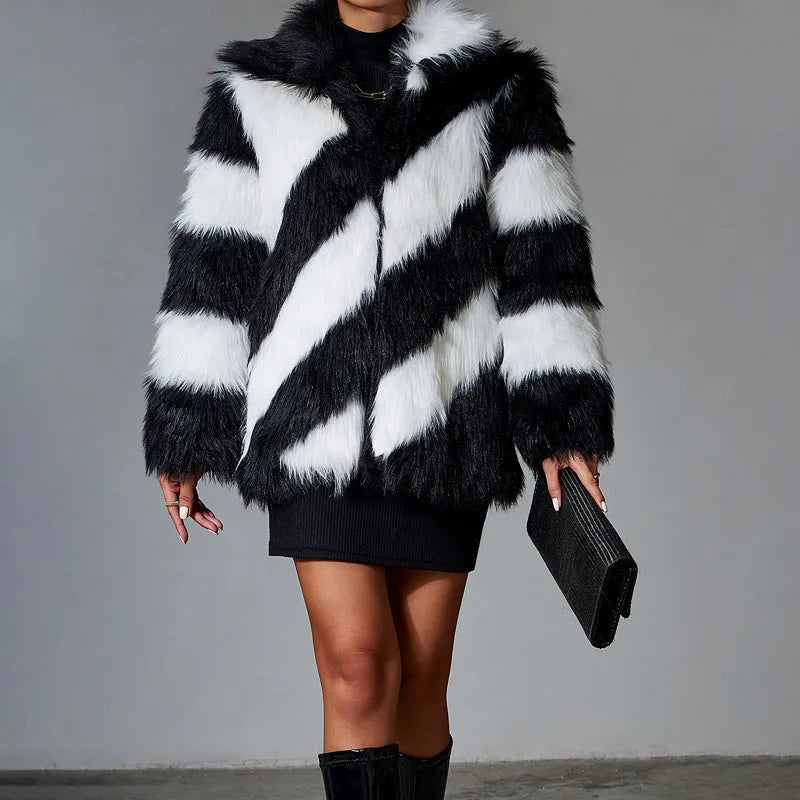 Women's grey faux fur coat with black contrast lapel and a large detachable faux fur collar.