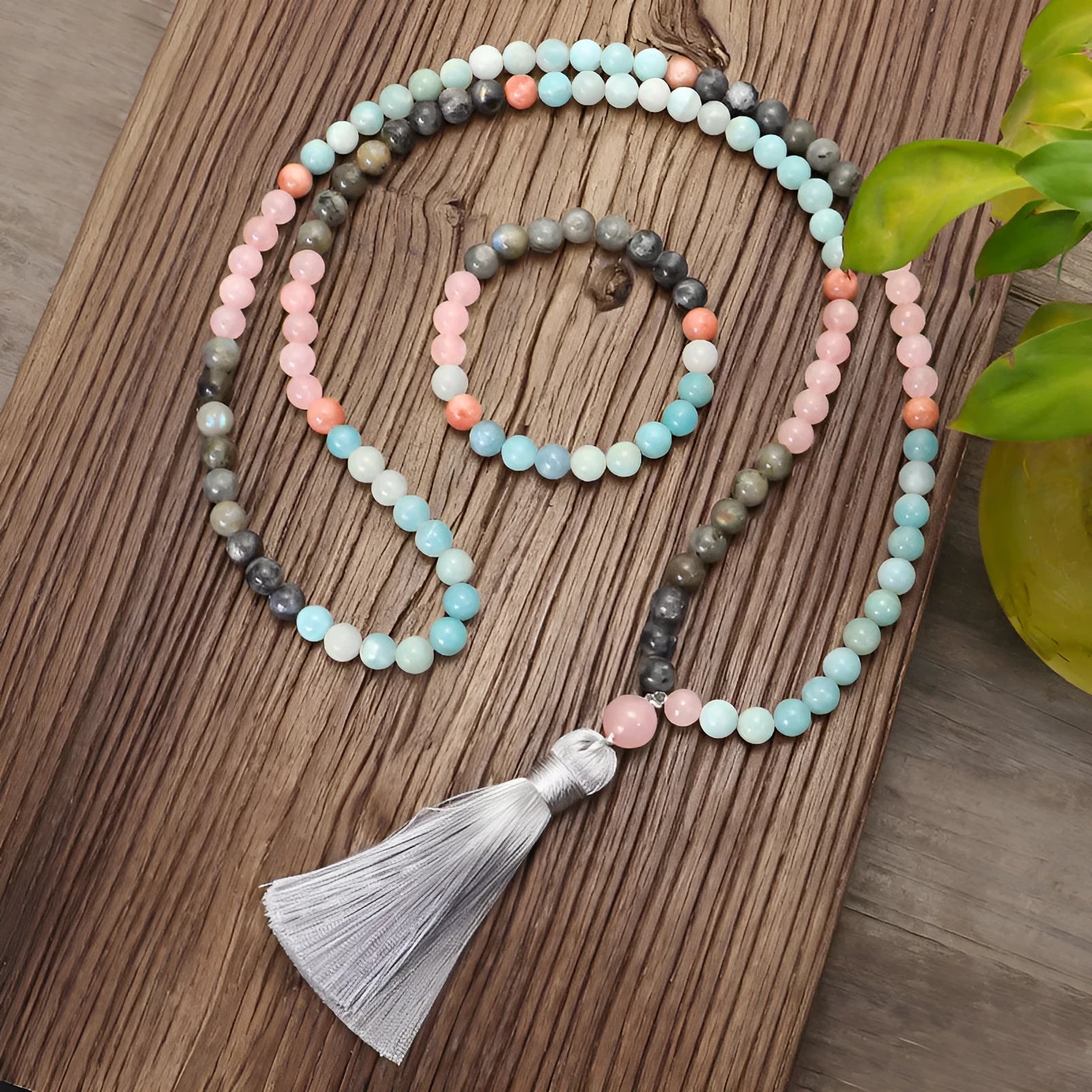 Bohemian 108 colourful stone necklace with drop-shaped tassel pendant on white background