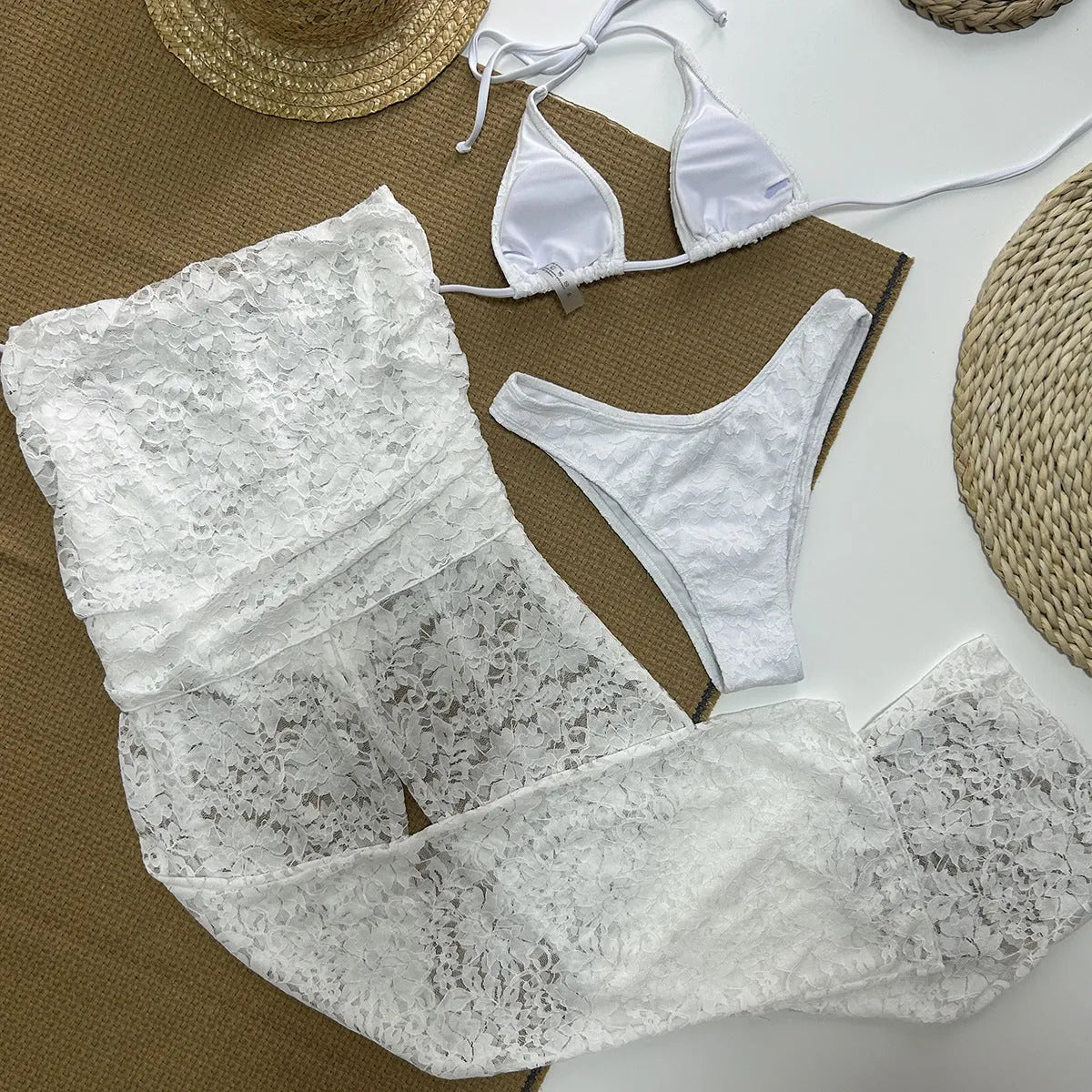 Solid white three-piece women's swimsuit set with nylon and spandex fabric