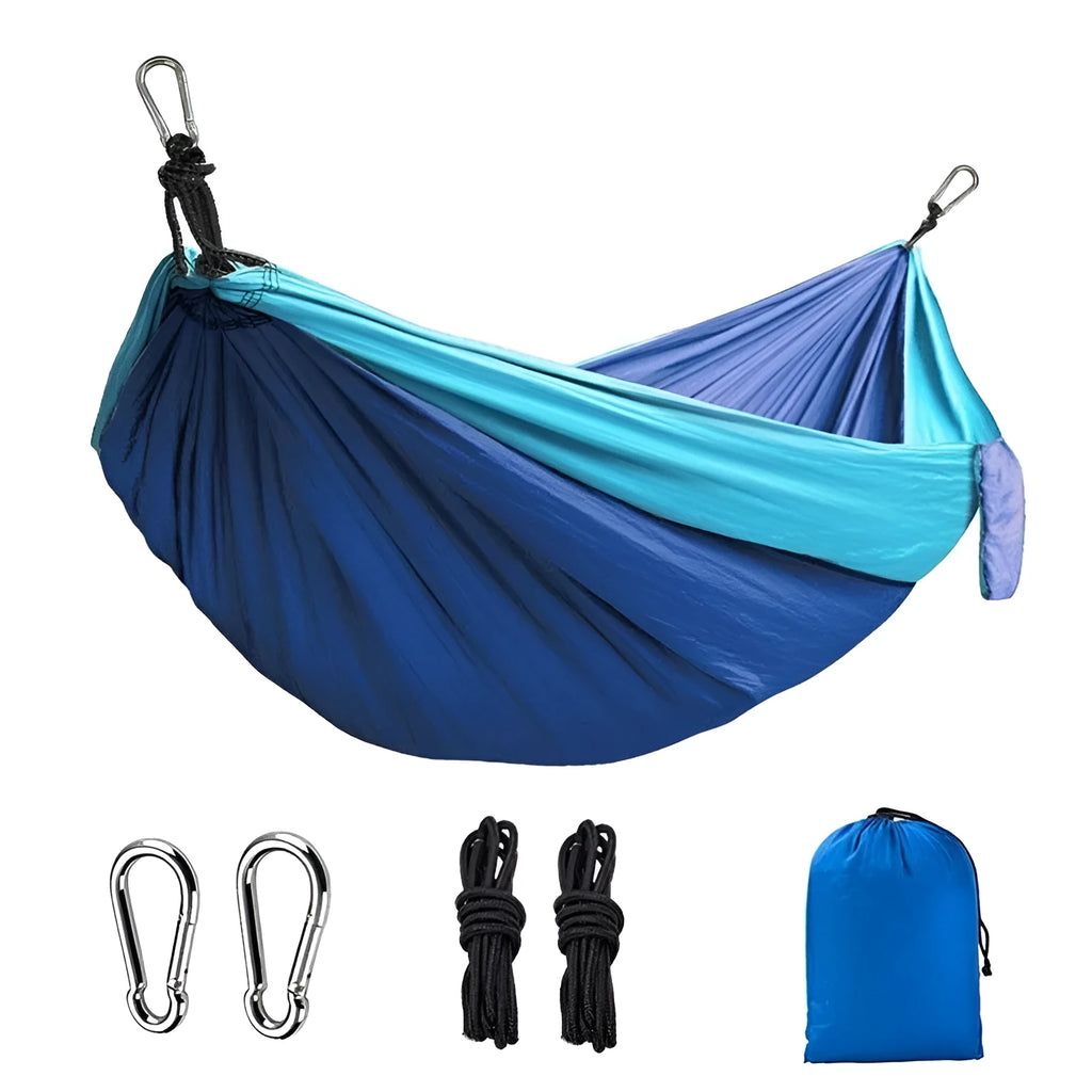 Blue parachute nylon outdoor camping hammock hung between two trees.