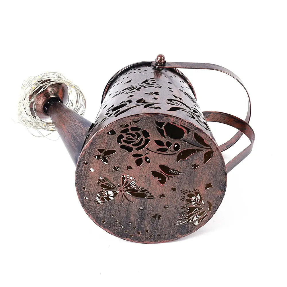 Tapered butterfly pattern solar garden lamp in warm white iron for outdoor decoration.